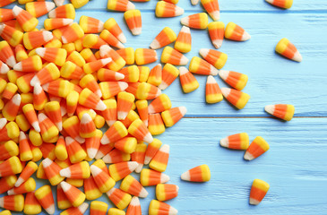 Colorful Halloween candy corns on wooden background