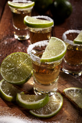 Tequila shots on wooden background