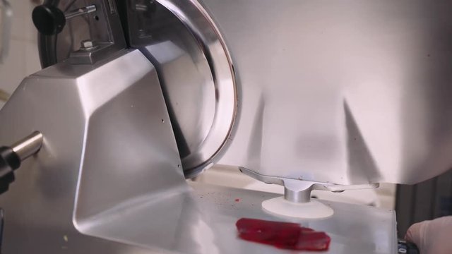 Kitchen, slicing beets on slices, machine for slicing slices. Close-up. 4k footage.

