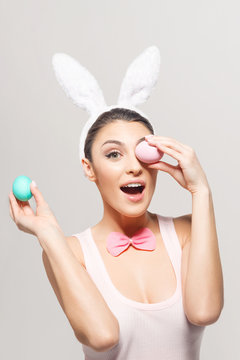 Playful young woman with Easter eggs
