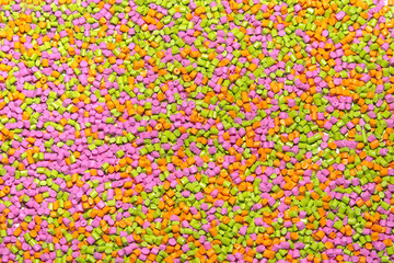 Polymeric dye for plastics. Pigment in the granules on a light background. 