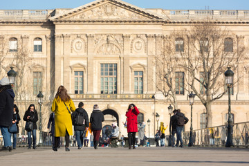 Naklejka premium People of Paris and tourists walking on the streets surrounded with historical buildings and landmarks