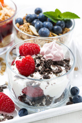 desserts with fresh berries in glasses, vertical closeup