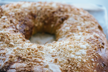 Close Up Of of sweet bread ringed dessert with sugar and almonds. On oven plate