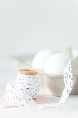 Fototapeta na wymiar Easter eggs on white wooden background with pink envelope