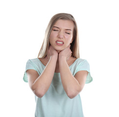 Sick young woman having pain in throat on white background