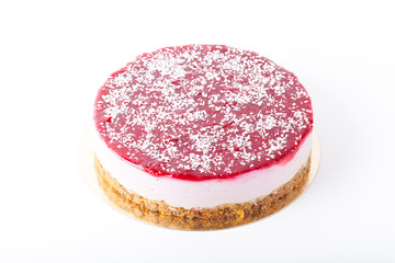 Homemade cheesecake with raspberries jam on a light background