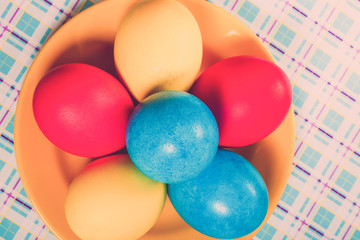 Easter symbols - colored eggs on light background. Toned