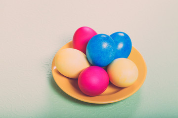 Easter symbols - colored eggs on light background. Toned