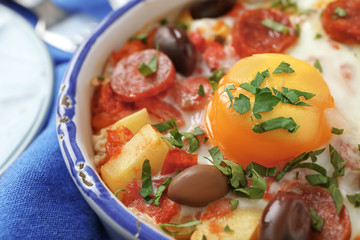 Baking dish with tasty Spanish baked egg, closeup