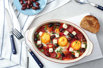 Delicious Spanish baked eggs in baking dish on table