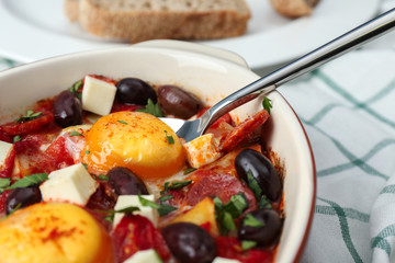 Delicious Spanish baked eggs in baking dish on table, closeup