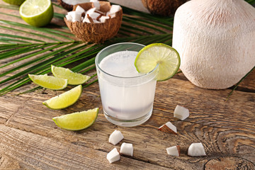 Composition with fresh coconut milk on wooden table