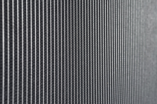 Auto engine radiator grille industial background.