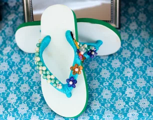 Selbstklebende Fototapeten Sandals decorated with beads © muangsatun