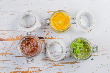Selection of colorful hummus in jars