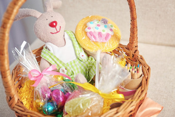 Easter basket with sweets and presents, closeup