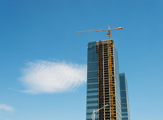 Fototapeta na wymiar Construction site with cranes on blue sky background.