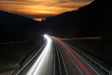 sunset over the dark highway