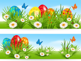Easter banners with multicolored eggs in a grass