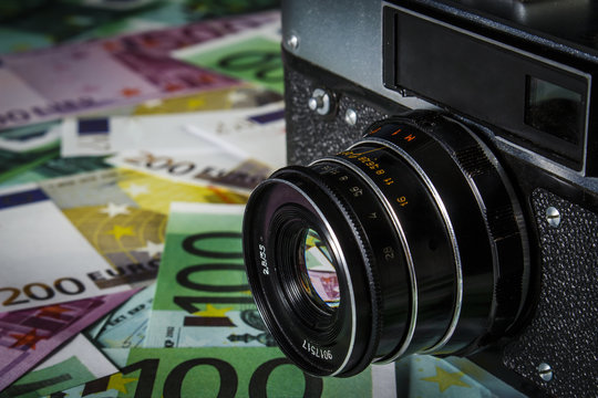 Old Soviet camera on a pile of euros