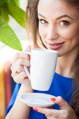 Beautiful young woman drinking a cup of coffee. Coffee drinker.