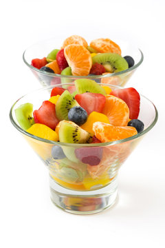 Fruit salad in crystal bowl isolated on white background
