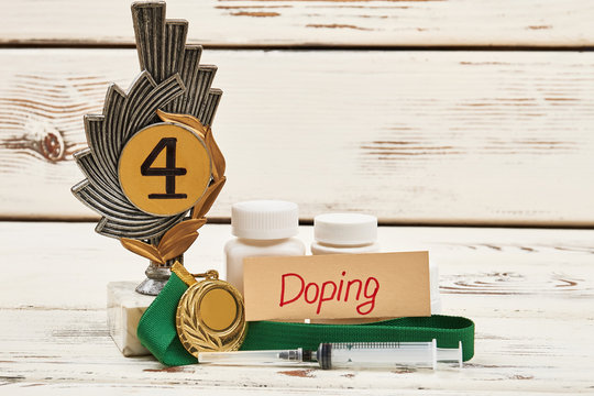 Awards, container and syringe. Doping sport concept.