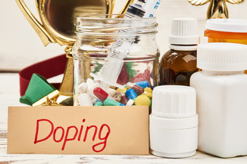 Pill containers and card. Doping is unfair game.