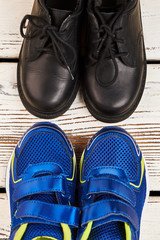 Stylish sneakers and black boots. Footwear for walking outdoors.