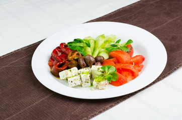 Salad With Cucumber, Tomatoes Cheese Cubes, Olives And Grilled Red Peper