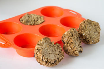 Bread from rye flour with seeds in silicone orange bakeware white background