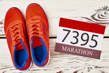 Sneakers and participant number. How to train to marathon.
