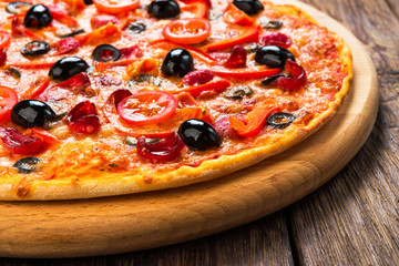 Delicious pizza with salami, mushrooms and olives