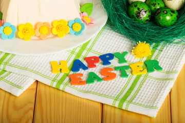Inscription HAPPY EASTER, Easter eggst, Easter cheese dessert, flowers and towel.