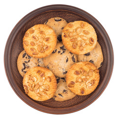 Cookies with peanuts and chocolate in a brown plate. Isolated on white background.