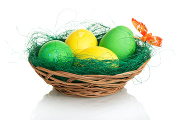 Fototapeta na wymiar Colored Easter eggs in basket isolated on white background.
