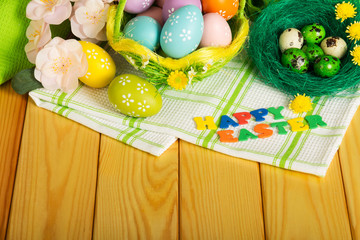 Obraz na płótnie Canvas Inscription HAPPY EASTER, colored Easter eggs, flowers, towel and light tree.