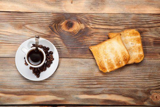 Breakfast, toast and coffee on a wooden background