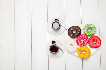Fototapeta na wymiar Two cups of tea and donuts on a white wooden table