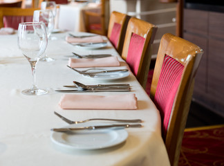 fork and knife on a napkin with plate.