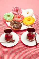 Two cups of tea on a red table