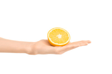 Healthy eating and diet Topic: Human hand holding a half of orange isolated on a white background in the studio