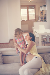 Obraz premium Pregnant woman and her little daughter.