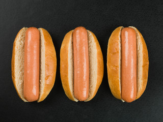 Three Hot Dogs in Bread Buns