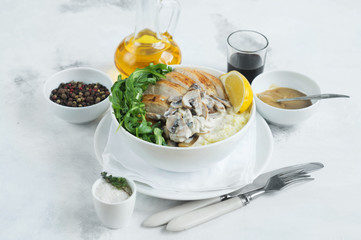 Healthy lunch chicken breast couscous arugula leaves and mushrooms