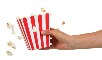 Female hand holding large square box popcorn on white.