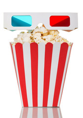Striped box filled with popcorn and 3D glasses on white.