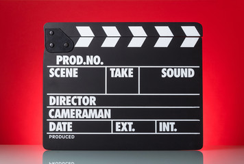 Black with white letters clapper on bright red background.