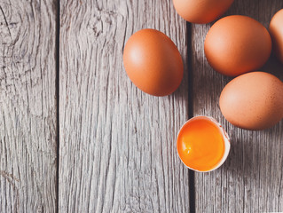 Fresh chicken brown eggs on rustic wood, organic farming concept background